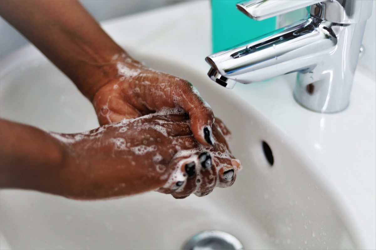 Woman washing her hands with hand soap.