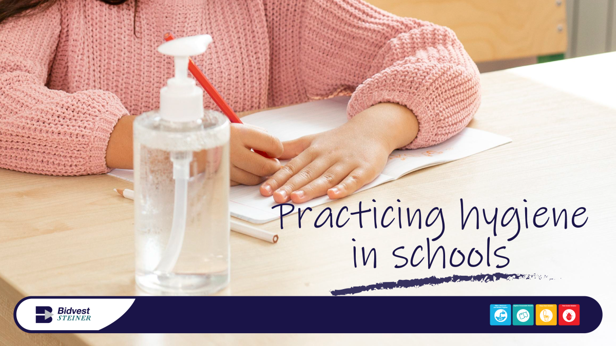 school child using hand sanitiser