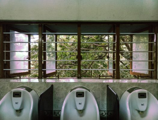 Urinals and a window in a public bathroom
